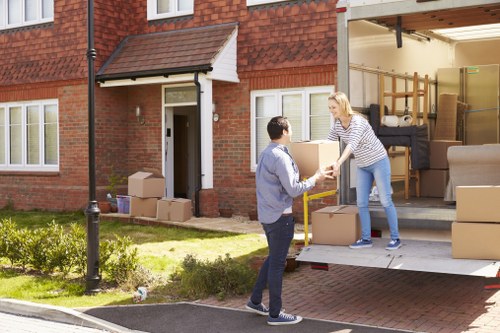 Removal van service handling a flat move in a busy north London street